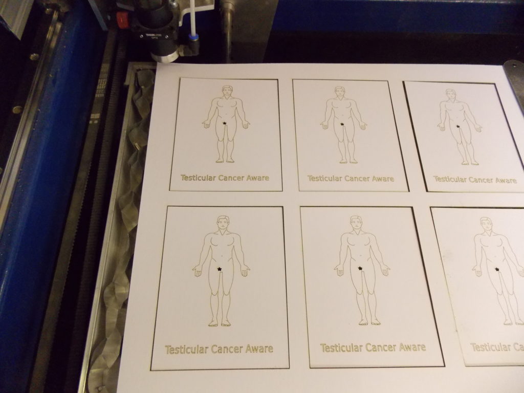 A set of laser cut testicular cancer awareness cards